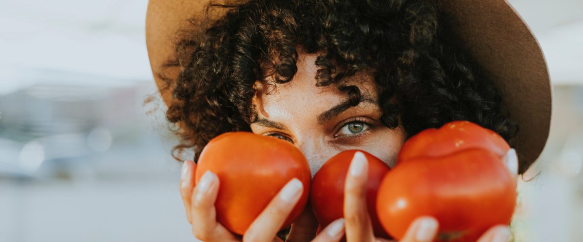 woman holding tomatoes