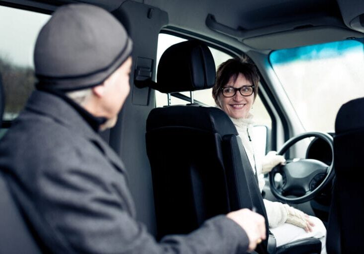 senior man sitting in paratransit van